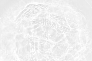 White water with ripples on the surface. Defocus blurred transparent white colored clear calm water surface texture with splashes and bubbles. Water waves with shining pattern texture background.