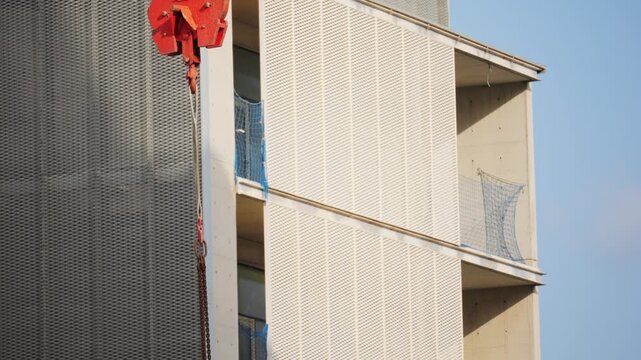 Crane and building under construction against blue sky