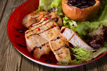 Fried chicken fillet with sauce and lettuce leaves