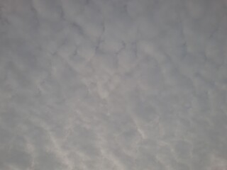 Cloudy sky with dramatic cracks of sunrise light breaking