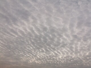 Cloudy sky with dramatic cracks of sunrise light breaking