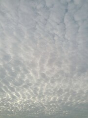 Cloudy sky with dramatic cracks of sunrise light breaking