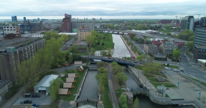 Aerial view of the Lachine Canal, a National Historic Site, in Montreal, Canada. The canal is used for recreation and tourism. Old industrial buildings line the canal.