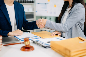 Woman lawyer hand and women client shaking hand collaborate on working agreements