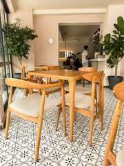 Cozy interior of a cafe with wooden furniture and beautiful tile flooring in the afternoon