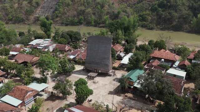 Aerial drone footage above a Bahnar village and the traditional wooden community house in Kon Tum province, Vietnam 1-2
