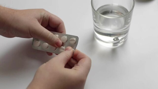 taking medicine painkiller pills on hand capsules health care medicare pharmacy and treatment concept close up