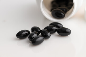 Close up of Astaxanthin Supplements on Light Background