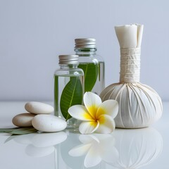 A serene photograph of a spa flat lay with a bowl of plumeria flowers and rolled towels