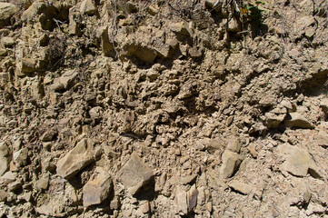 A detailed view of a quarry that is no longer in use. A detailed view of the crumbling remains of stone quarrying.