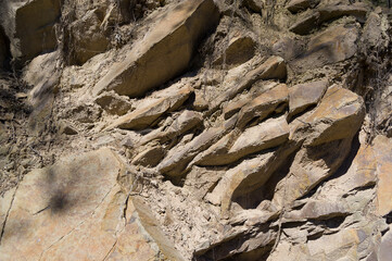 A detailed view of a quarry that is no longer in use. A detailed view of the crumbling remains of stone quarrying.