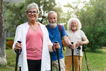 Group portrait of active seniors practicing nordic walking. Healthy sport for elderly people