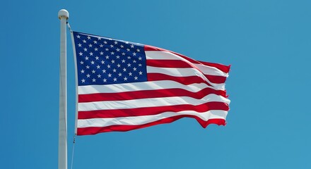 Fototapeta premium American Flag Flying in Clear Blue Sky with Bright Sunlight
