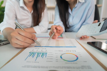 Collaboration. Businesswomen analyzing financial reports together in modern office.