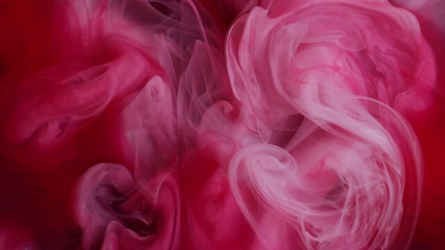 Mix ink fluid. Acrylic color. Defocused red crimson pink cloud pouring in water particles fume drop floating on abstract background.