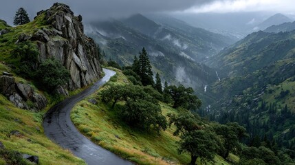 Winding road ascends, misty mountain valley view.
