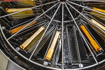 Close-up of a honey extractor with frames of honeycomb, ready for harvesting. This image represents beekeeping and sustainable practices in agriculture and food production.