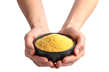  Two hands cradle a black bowl filled with yellow powder.