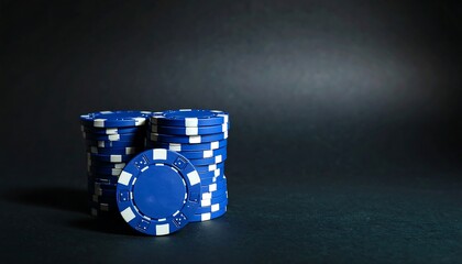 Blue poker chips stacked on dark background