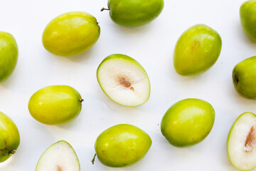 Green jujube fruits on white background.