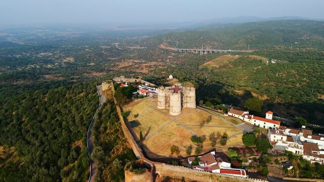 Pull-back ascend reveals Evoramonte Castle above Alentejo plains, Estremoz, Portugal