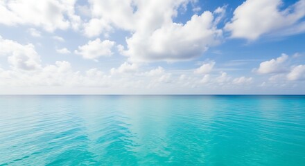 Obraz premium Azure Ocean Meets Sky: A Tranquil Seascape with Fluffy Clouds and Calm Waters