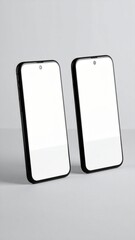 Two sleek, modern smartphones with bright, blank white screens provide an ideal minimalist backdrop for showcasing digital designs or content concepts in a clean setting.