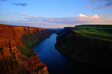 Fototapeta premium Majestic river carving through dramatic canyon landscape at dusk
