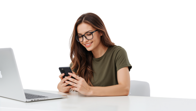 Smiling woman using a smartphone with a laptop on a white desk isolated background