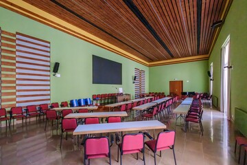 Modern Conference Room With Wooden Ceiling And Green Walls. Multipurpose classroom, red chairs, audio visual equipment, meeting space, educational facility In Montserrat Hospitality Center.