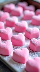 Pink heart-shaped candies on a baking sheet (1)