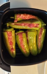 Large green chilies are deseeded and stuffed with seasoned minced pork and baked in an air fryer.