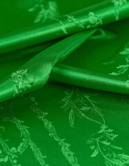 Emerald green fabric with delicate floral patterns