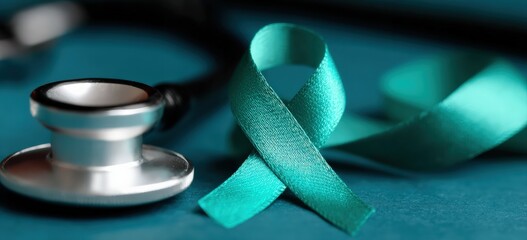 Teal awareness ribbon for ovarian cancer, cervical cancer, sexual assault, and polycystic ovary syndrome near a stethoscope on a table