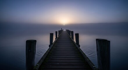 Naklejka premium Wooden Pier Leading to Misty Lake at Sunrise in Serene Landscape