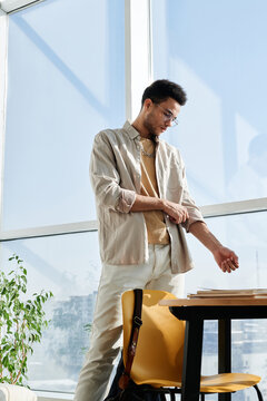 Vertical image of young man dressing up in his room at home and going to college