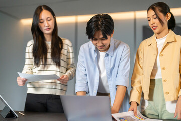 Fototapeta premium Crm software and customer management system team of asian business professionals analyzing data reports and marketing strategies, teamwork meeting improve sales service customer relationship at office
