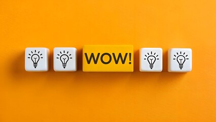 Creativity and Standout Idea Concept – White Blocks with Light Bulbs and Yellow “WOW!” Block, Innovation, Abstract, Orange Background