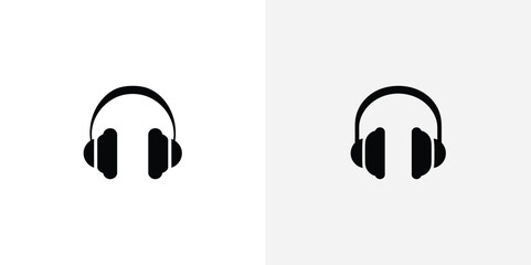 Two simple black silhouette icons of headphones on white backgrounds