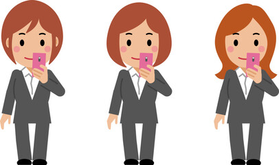 スマホを見るグレースーツの若い女性