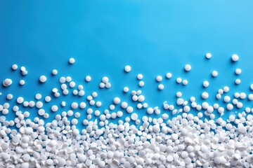 White pills scattered on a blue background