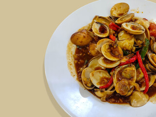 A plate of clams cooked with Padang sauce. Seafood cuisine from Indonesia. 