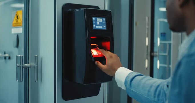 Man using biometric fingerprint scanner for secure access control in modern office