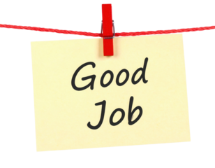 A colorful note displaying the message "Good Job" clipped to a string, symbolizing recognition and encouragement.