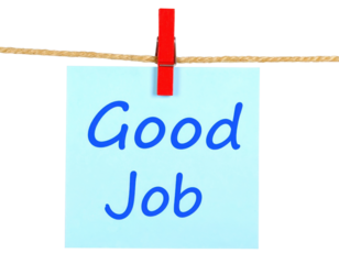 A colorful note displaying the words "Good Job" attached to a string with a clothespin.
