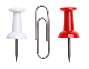 A collection of office supplies featuring a white pushpin, red pushpin, and a silver paperclip.