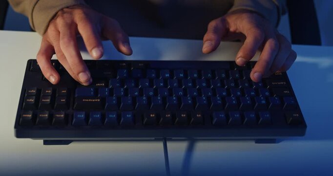 Closeup young adult male freelance developer typing write prompt AI bot app program nomad terminal coding at office night. Artificial intelligence dashboard, robotics user interface, machine learning.