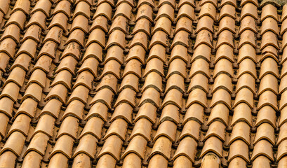 orange and brown old tile roof texture background. Old vintage roof tiles backdrop for concept and design.