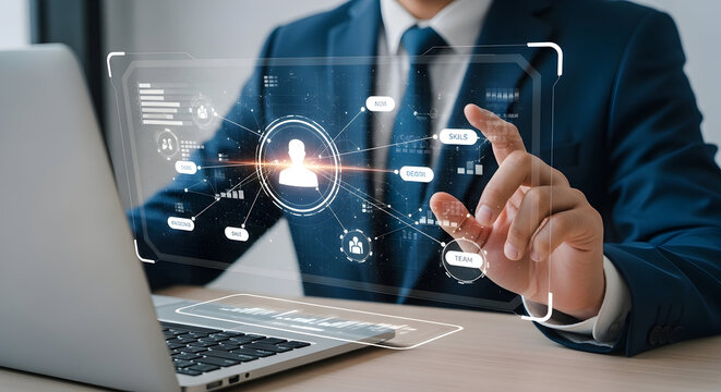 Businessperson using digital interface with modern technology, showcasing concepts of data analysis, networking, and human resources in the workplace environment.