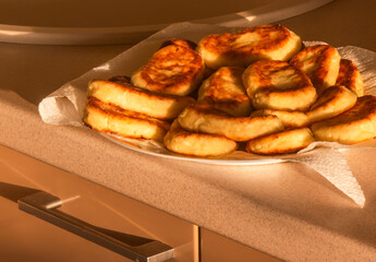 Plate of delicious homemade cheese pancakes resting on kitchen counter